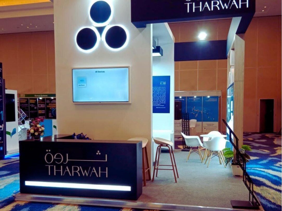 Tharwah exhibition stand reception by Story Design, with screen and seating